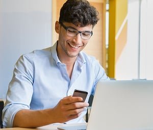 Happy Developer Reading the Pros of Low-Code Development | Estel Tech