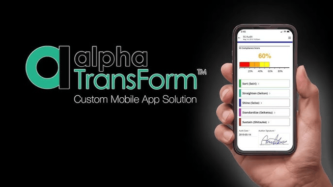 Hand holding a smartphone displaying the Estel Tech Transform app with a compliance score, alongside the Estel Tech Transform logo.