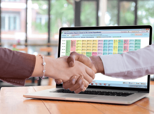 Two people shaking hands in front of a laptop displaying a colorful digital timetable or scheduling software.