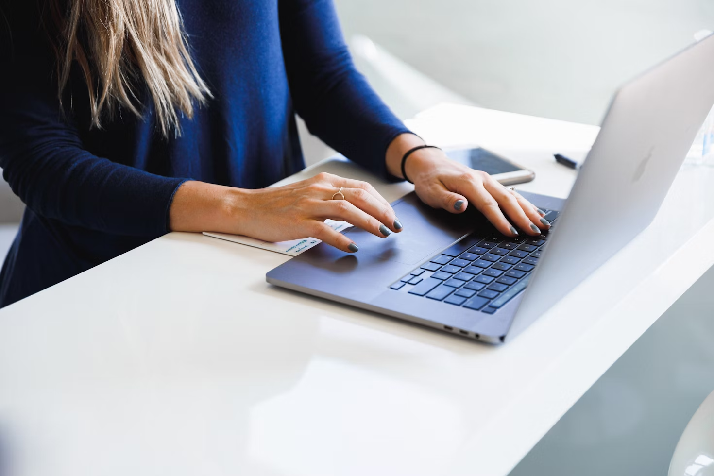 Business professional doing work on a laptop.