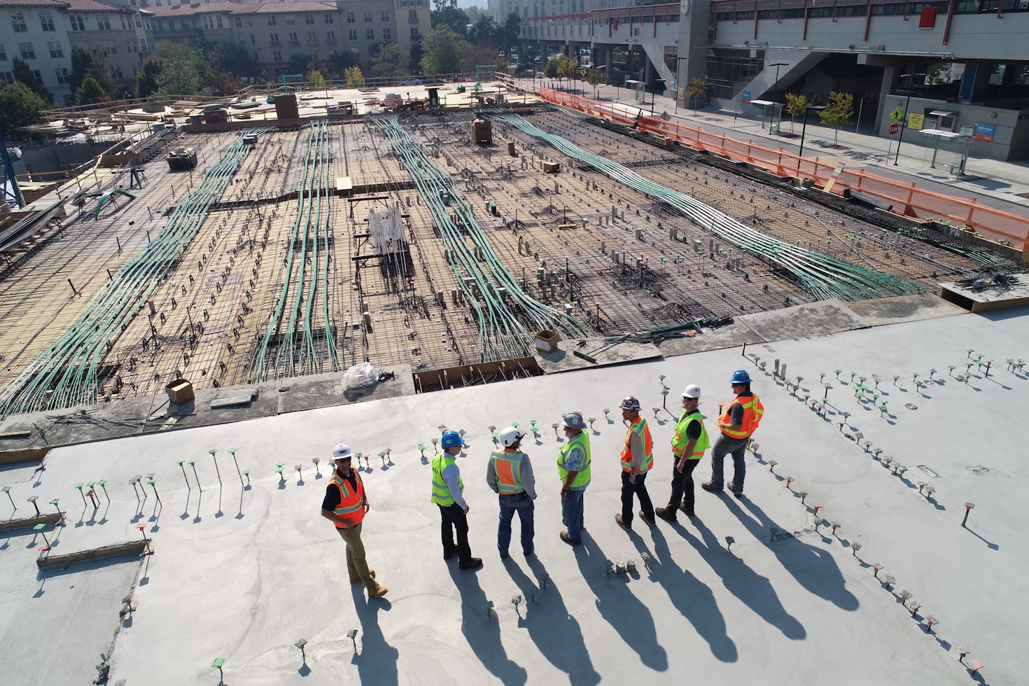 Seven construction workers listening to a toolbox talk